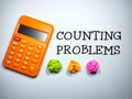 Selective focus.Word COUNTING PROBLEMS with calculator and colorful crumpled paper on white background.Business concept. Royalty Free Stock Photo