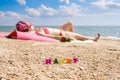 Selective focus on the word Happy on the background of a tanning girl. Royalty Free Stock Photo