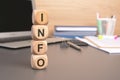 the word INFO written on wooden cubes against computer keyboard background Royalty Free Stock Photo
