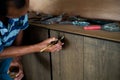 Selective focus on wrinkle hand of old male carpenter works at house under construction