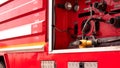 Yellow gauge pressure with valve lever and high pressure fire safety pump on side view of red fire truck Royalty Free Stock Photo