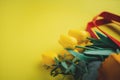 Selective focus of yellow tulips in shopping bag