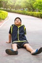 Selective focus at young Asian boy sit and tired on track after running. Royalty Free Stock Photo