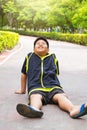 Selective focus at young Asian boy sit and tired on track after running. Royalty Free Stock Photo