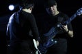 Selective focus on young Asian man bassist playing electric bass duo with guitarist player on stage at concert Royalty Free Stock Photo