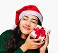 Selective focus Young beautiful asian woman wore green sweater and santa hat,Excited, surprised and happy, Holding a gift box with Royalty Free Stock Photo