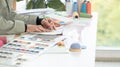 Selective focus on young hand of fashion designer, sketching or drawing creative clothes on paper on working desk at workplace Royalty Free Stock Photo