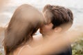 Selective focus of man kissing brunette