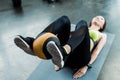 Focus of young woman exercising with ball on fitness mat in gym Royalty Free Stock Photo