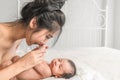 Little newborn infant baby lying on bed with mother holding hand Royalty Free Stock Photo