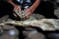 Selective focused on the dirty wrinkled skin hands of old man molding the clay work on the spinning wheel for making the jar with Royalty Free Stock Photo