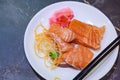 Selective Focused Japanese salmon sashimi fresh fatty salmon meat decorated with grated turnip and carrot in white dish on Royalty Free Stock Photo