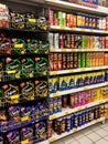 Selective focused of packed miscellaneous brand and type of junk foods & snacks on rack and display for sale in the supermarket.