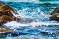 Sea water wave with stone rock of beach. Royalty Free Stock Photo