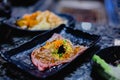 Selective focust to set of grilled Wagyu beef sushi with fish roe and Tobiko on black plate in Japanese restaurant