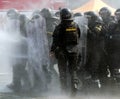 Selective of a group of policemen with shields during a riot