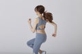 Selective moving focus of Back side Asian girl pose running in studio