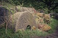 Selective of old stone millstones covered in lichen Royalty Free Stock Photo