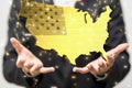 Selective shot of a businessman on blurred background holding patriotic usa flag map concept digital