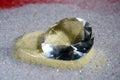 Selective shot of an expensive beautiful diamond isolated on golden raw sugar Royalty Free Stock Photo