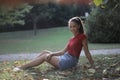 Selective shot of a female with a red shirt and denim skirt Royalty Free Stock Photo