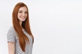 Self-assured motivated redhead talented female student blue eyes wearing striped t-shirt standing profile turning camera