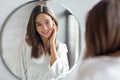 Self-Care Concept. Young Attractive Woman Looking At Mirror In Bathroom Royalty Free Stock Photo