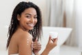 Self-Care Concept. Young Black Woman Applying Moisturising Body Lotion On Skin Royalty Free Stock Photo