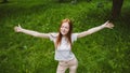 Self care, mental wellbeing, mental health, mindfulness. Young red-haired woman enjoying life in nature among flowers