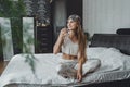 Self care, mourning routine, start day. Self Care Ideas for woman. Young woman lies on the bed and drinking water after