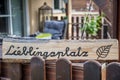 Self-carved wooden sign in a lounge corner with the word favorite place in german language Royalty Free Stock Photo