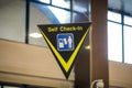 Self check-in sign inside an international airport Royalty Free Stock Photo