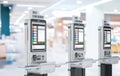 Self-checkout kiosks or self-service payment machines in a row