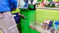 Self-checkout made by a male customer in a finnish supermarket