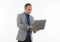 A self-confident middle age senior Asian man in a blue business casual shirt with a grey jacket standing and holding the notebook Royalty Free Stock Photo