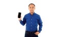 A self-confident middle age senior Asian man in a blue business casual shirt holding the smartphone. Isolate on white background Royalty Free Stock Photo