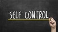 Self control concept. Hand with yellow marker writing self control inscription text on chalkboard. Royalty Free Stock Photo