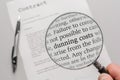 Self-created contract with the words `dunning costs` in a magnifying glass Royalty Free Stock Photo