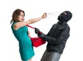 Self defense concept. Young woman is fighting with thief and using pepper spray. Royalty Free Stock Photo