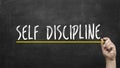 Self discipline concept. Hand writing self discipline inscription text on blackboard.