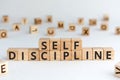 Self discipline - words from wooden blocks with letters