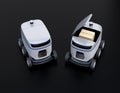 Self-driving delivery robots on black background. One`s cover opened for picking parcels Royalty Free Stock Photo