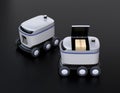 Self-driving delivery robots on black background. One`s cover opened for picking parcels Royalty Free Stock Photo