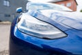 Self driving Tesla Model Y Exterior. Blue metallic, black titanium rims, panoramic sunroof, led headlights