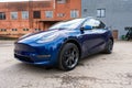 Self driving Tesla Model Y Exterior. Blue metallic, black titanium rims, panoramic sunroof, led headlights