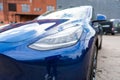 Self driving Tesla Model Y Exterior. Blue metallic, black titanium rims, panoramic sunroof, led headlights