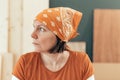 Self employed female carpenter looking out the window