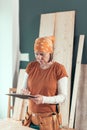 Self employed female carpenter writing project notes