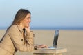 Self employed woman working with a laptop outdoors