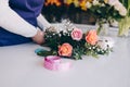 Self-employed young woman owner of florist shop arranging bouquet of roses Royalty Free Stock Photo